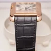The side view and watch strap of a Cartier Tank Anglaise 2002 Extra Large Rose Gold.