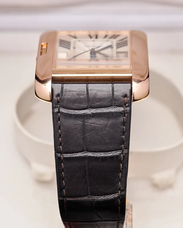 The side view and watch strap of a Cartier Tank Anglaise 2002 Extra Large Rose Gold.