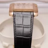 The side view and watch strap of a Cartier Tank Anglaise 2002 Extra Large Rose Gold.