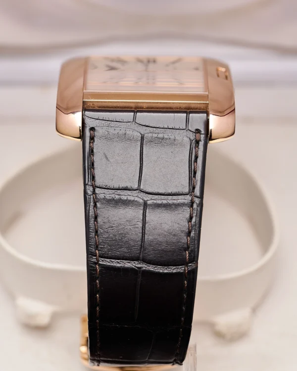 The side view and watch strap of a Cartier Tank Anglaise 2002 Extra Large Rose Gold.
