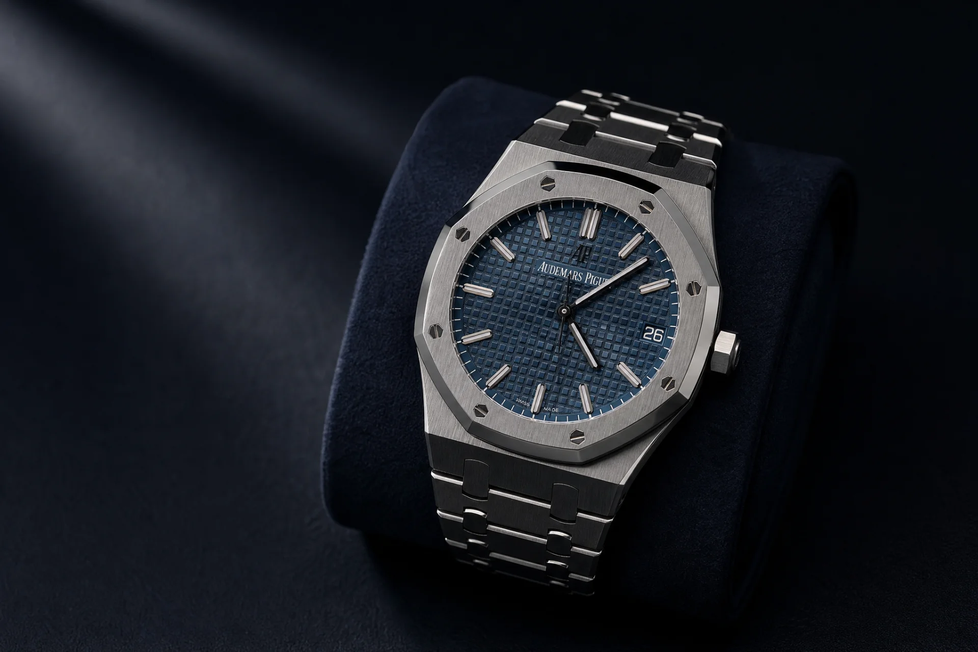 Audemars Piguet Royal Oak steel watch with blue tapisserie dial on a dark suede cushion